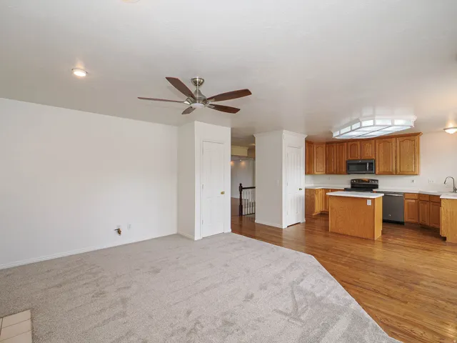 Open-concept living space with carpeted flooring
