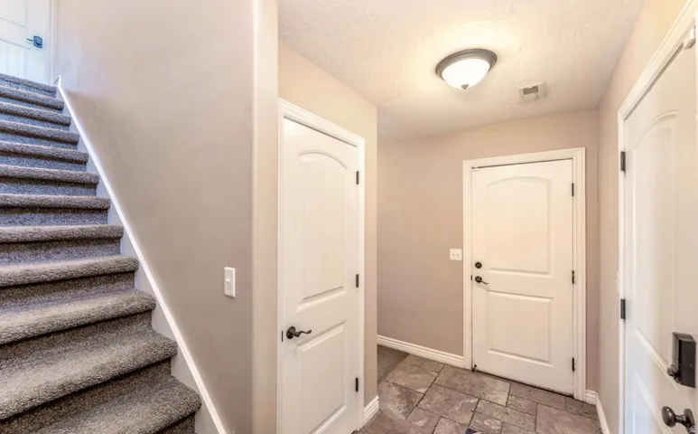 Carpeted staircase with white risers