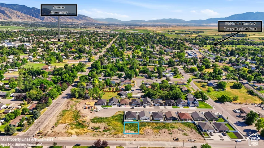 Overhead view of a developed residential area with a mountain backdrop