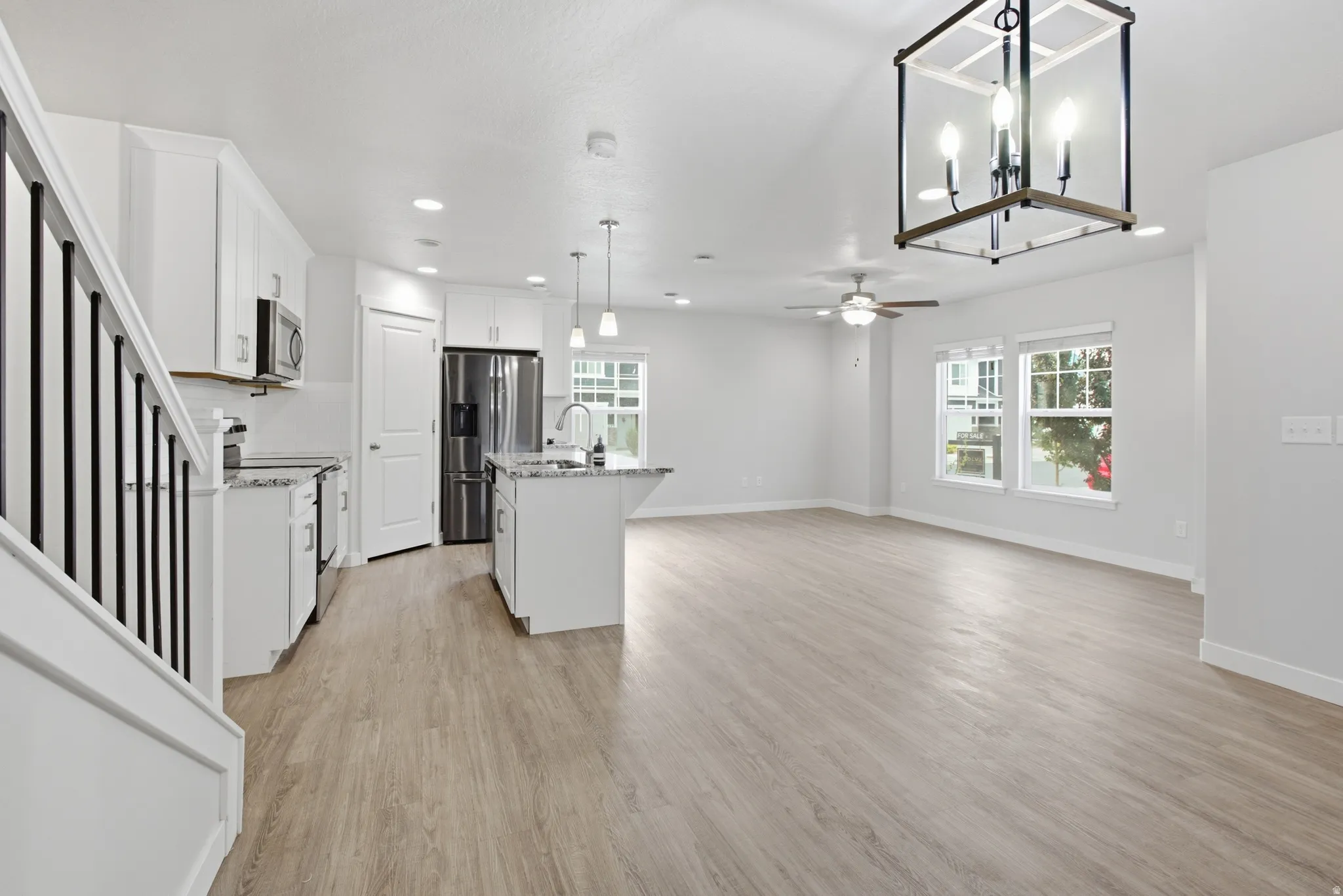 Open-concept living space with wood-finish flooring