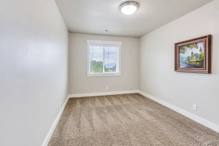 Neutral-toned room featuring light beige walls and complementary brown patterned carpet