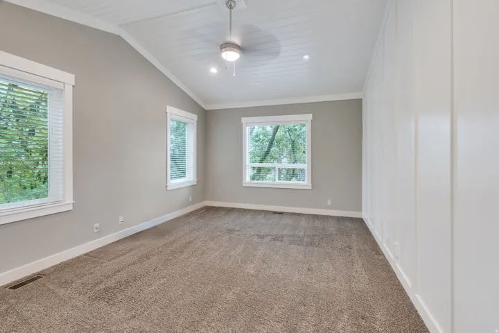 Room with vaulted planked ceiling, recessed lighting, and a ceiling fan