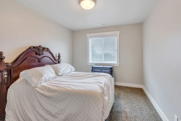 Neutral tone walls complement the window with white trim and blinds