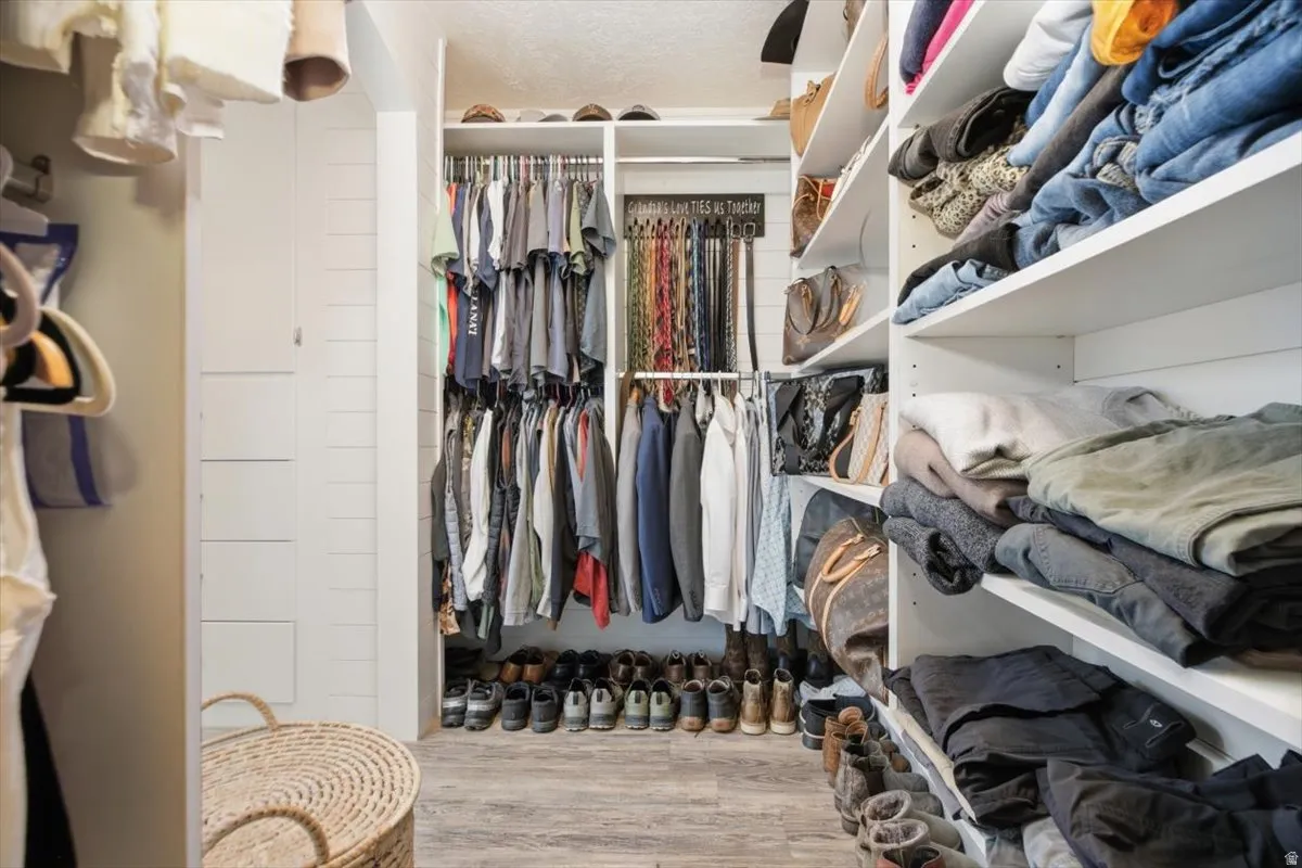 Custom closet system featuring extensive shelving, multiple hanging rods, and integrated shoe storage