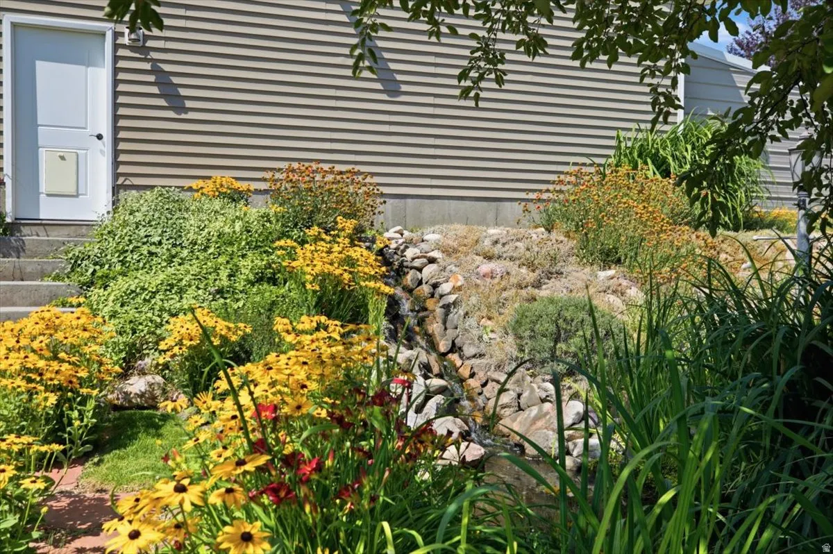 Detailed landscaping featuring a tiered rock garden with a prominent water feature
