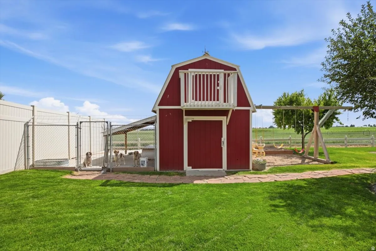 Red barn-style outbuilding featuring a second-story balcony