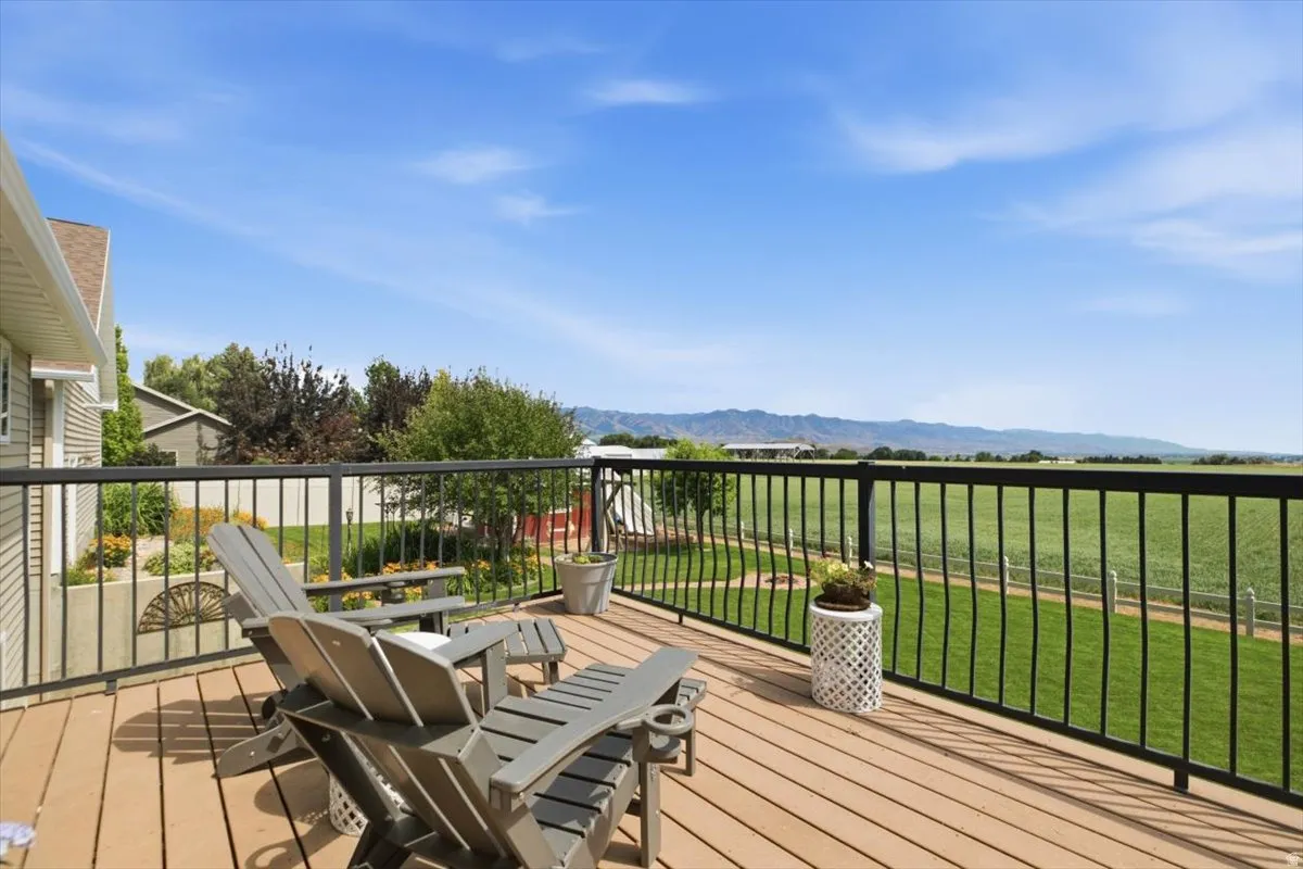 Expansive outdoor deck with composite wood-finish flooring and black metal railings