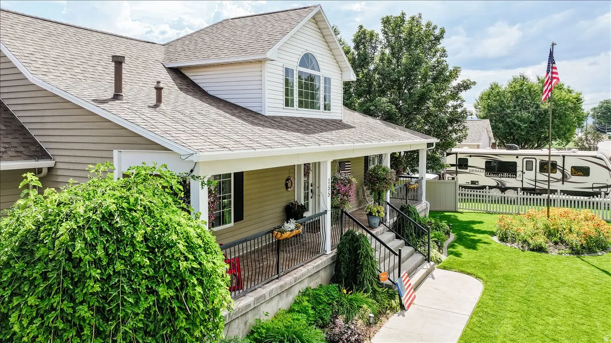Inviting property with a covered front porch featuring black railings
