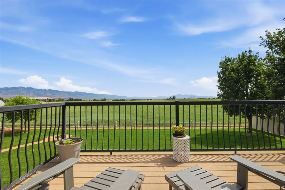 Spacious outdoor deck with composite decking and black metal railings
