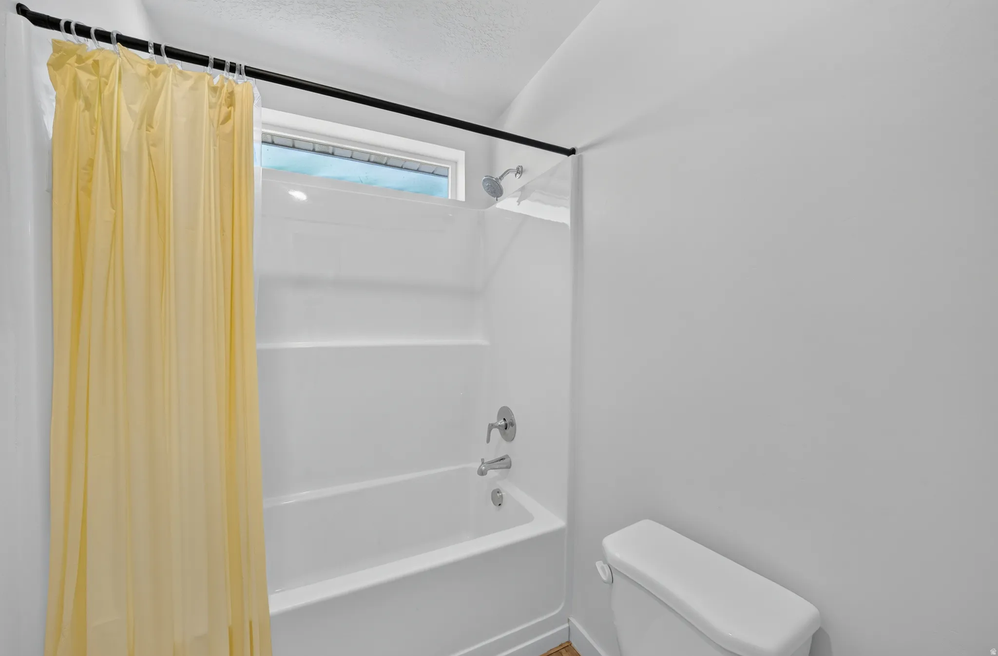 White acrylic tub-shower combination with integrated shelving