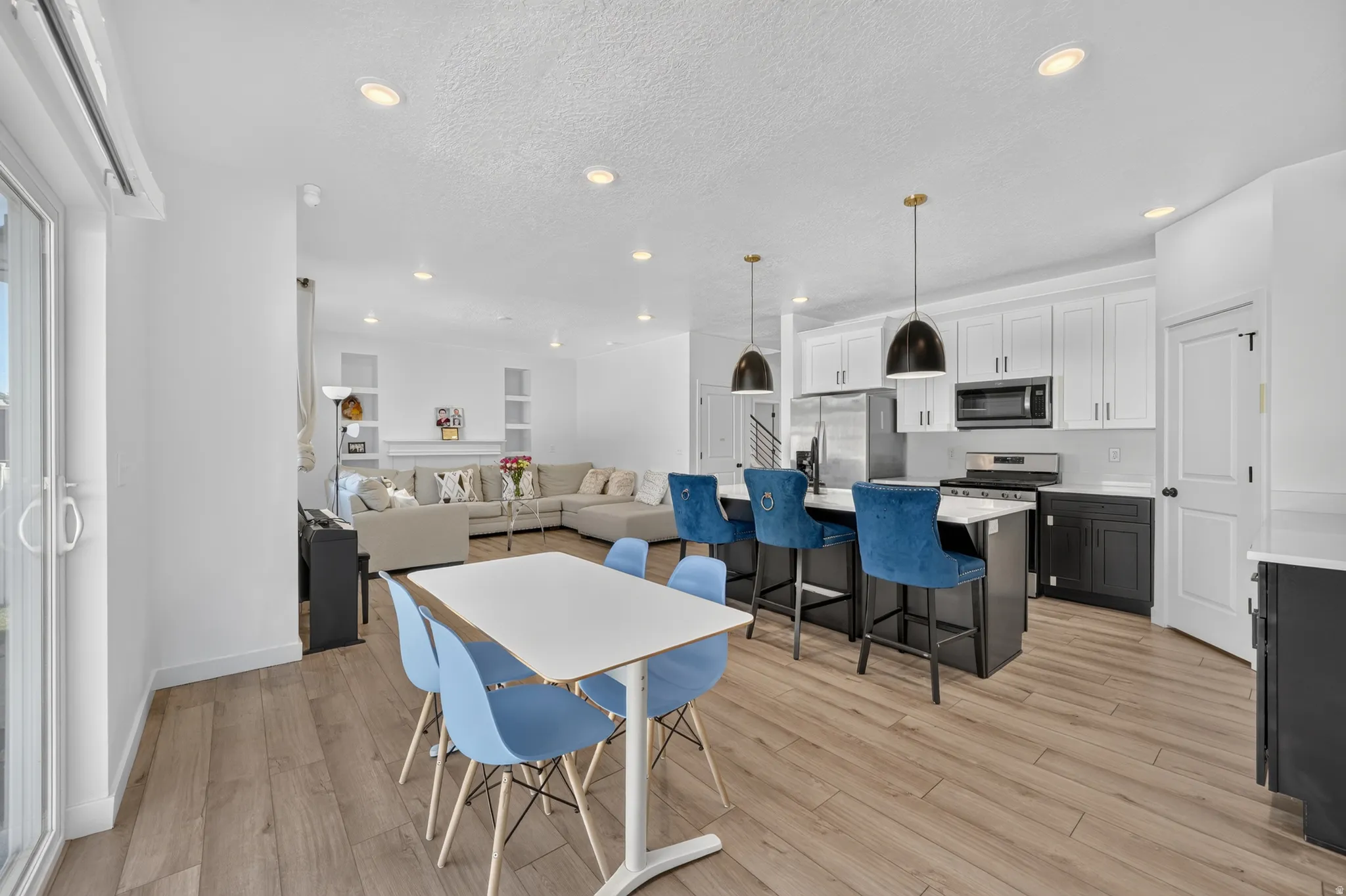Open-concept living area with wood-finish flooring