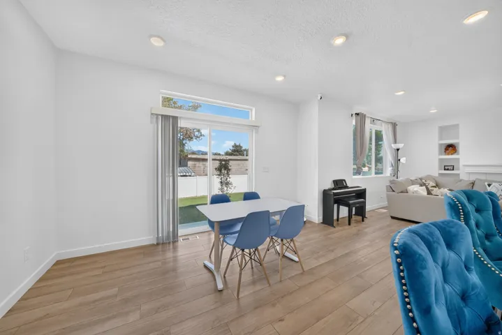 Open-concept living area featuring wood-finish flooring, recessed lighting, and white walls