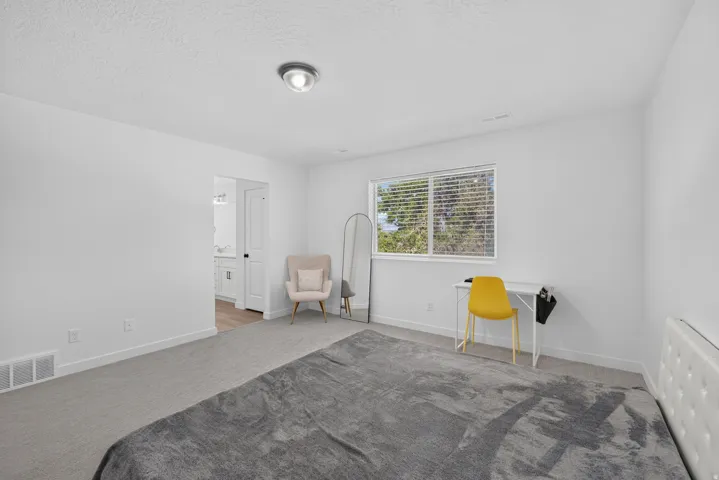 Bright room featuring light grey carpet, white walls, and a recessed window