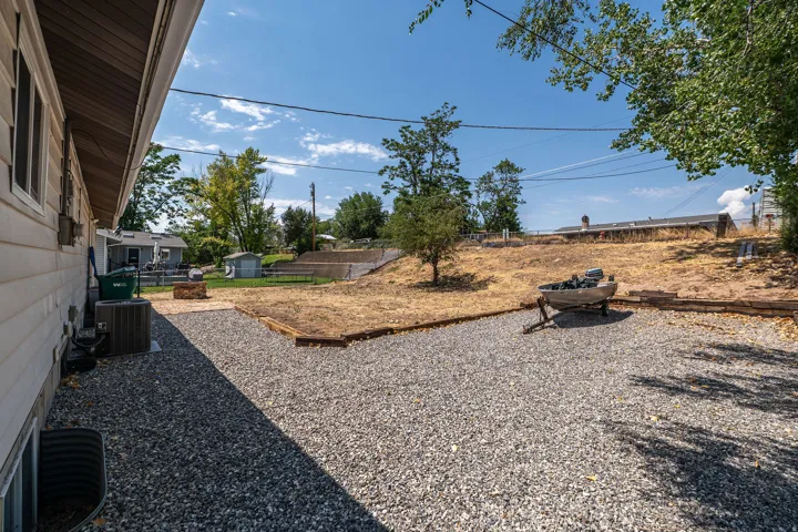 Expansive gravel yard area with a terraced landscape