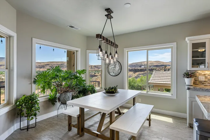Dining area with multiple windows offering expansive desert mountain scenery