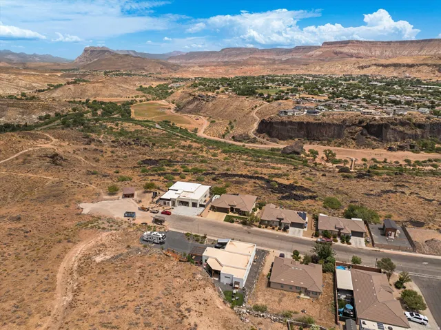 Aerial perspective showcasing residential development amidst a desert landscape with distant mountains