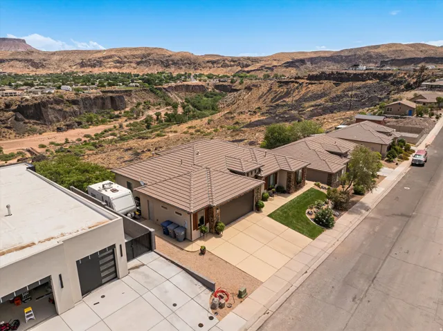 Contemporary residential property featuring a tiled roof, attached garage, and a concrete driveway
