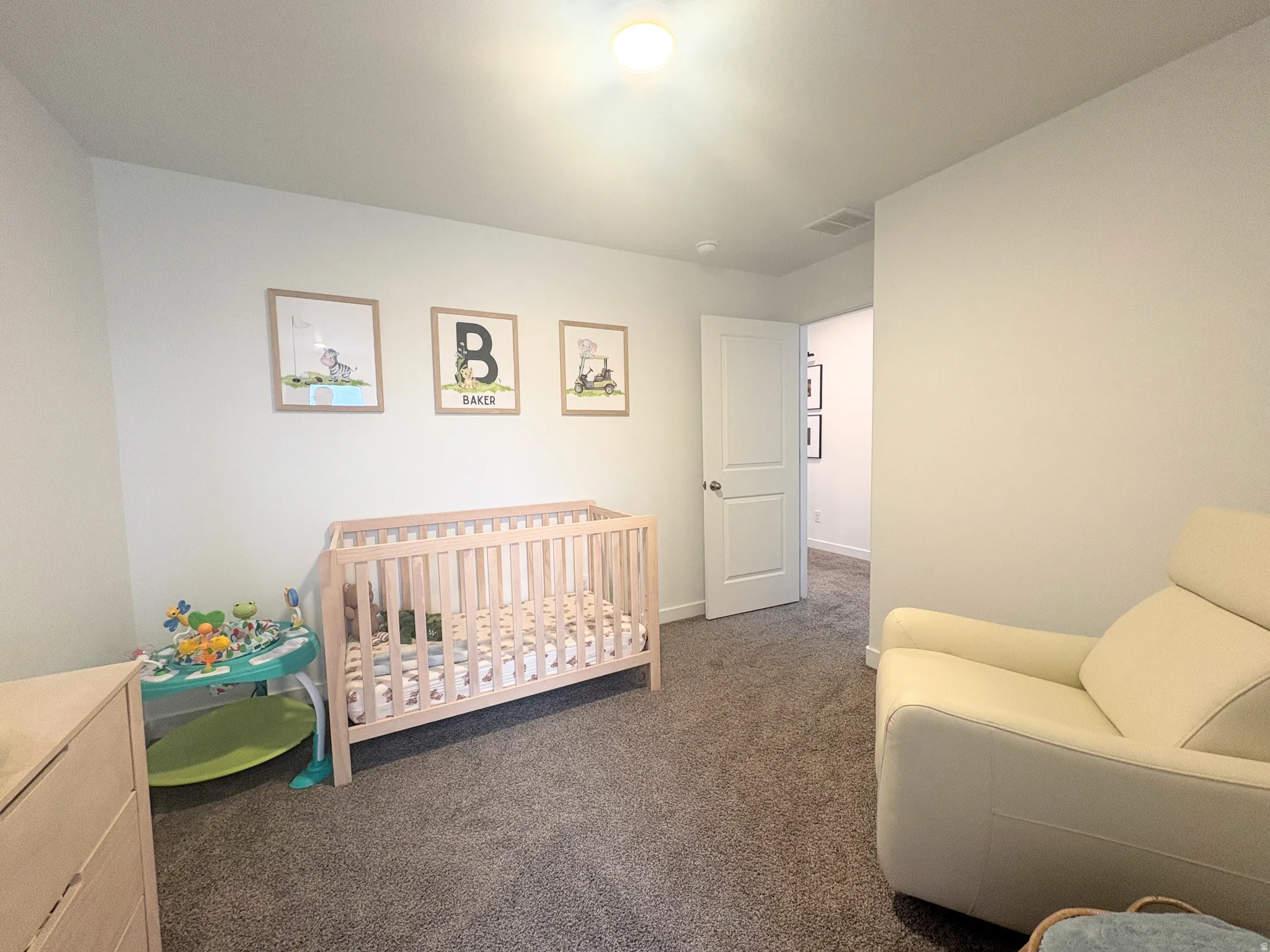 Room featuring neutral wall paint, overhead lighting, and carpet flooring