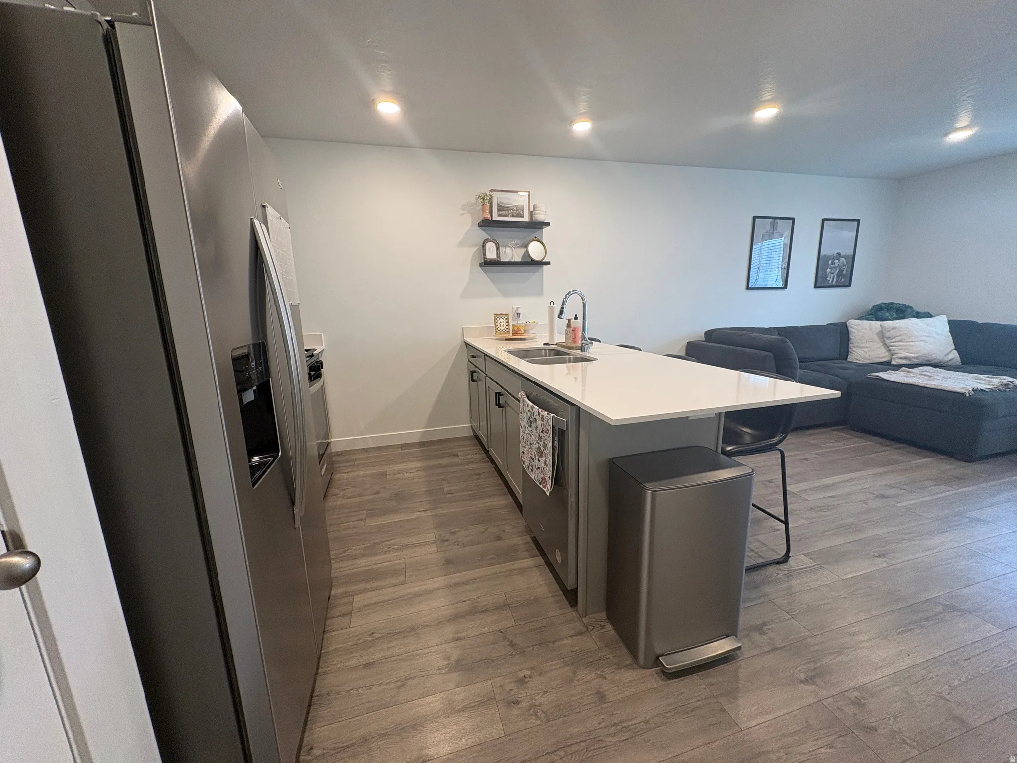 Open-concept living space with wood-finish flooring