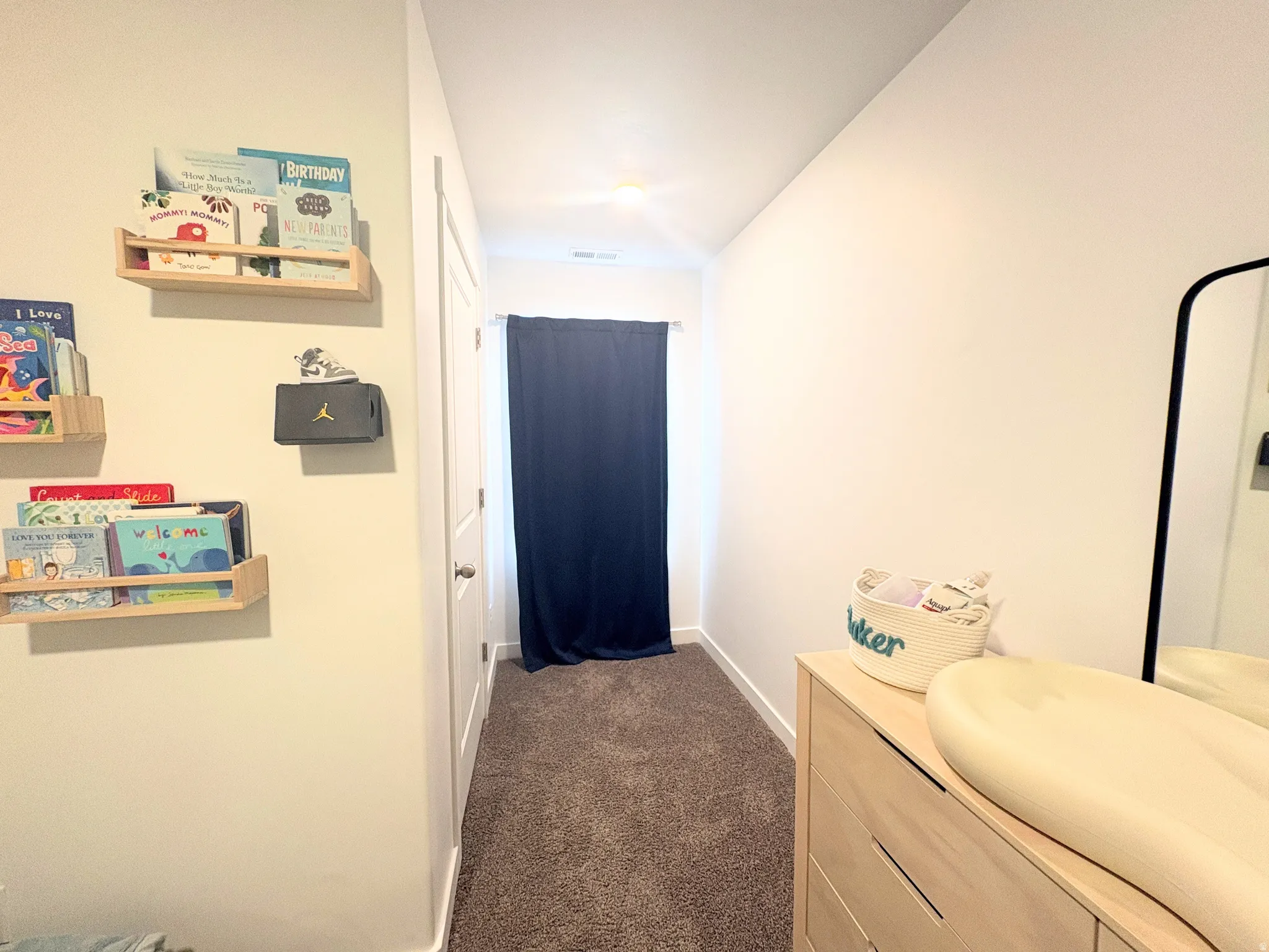 Neutral-toned walls complement plush carpeting