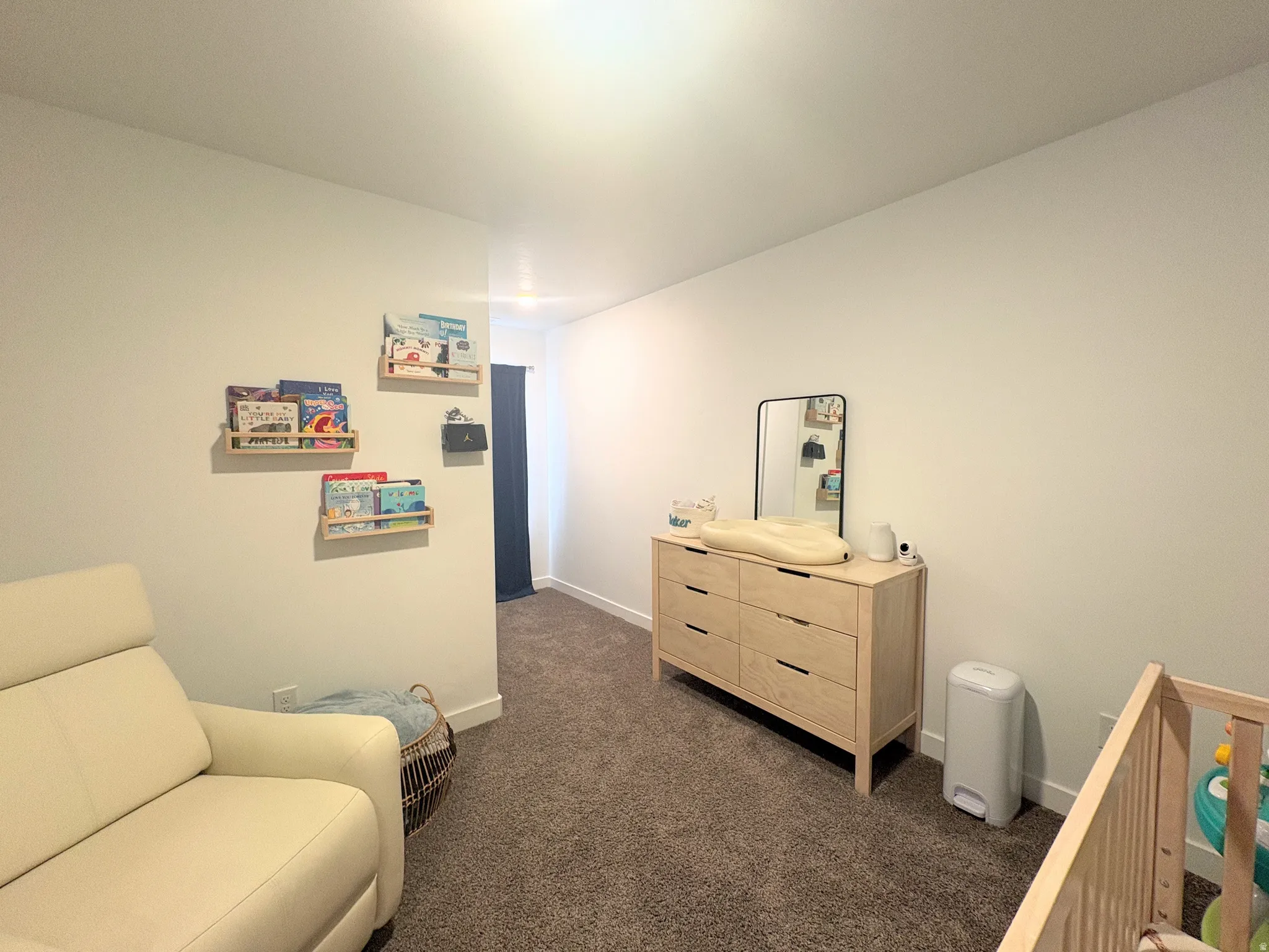 Neutral wall tones with plush carpet flooring