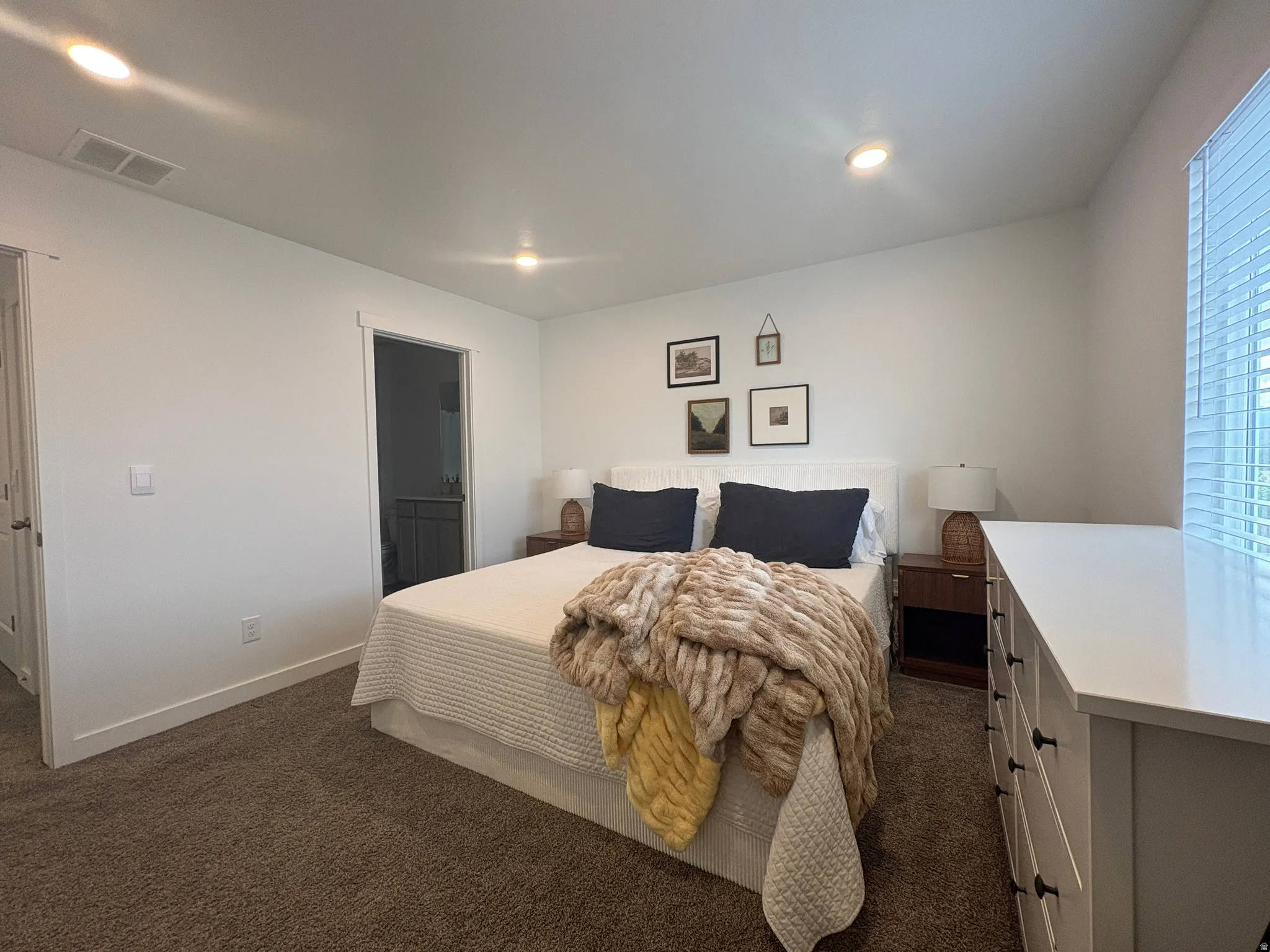 Carpeted bedroom featuring recessed lighting, a window with blinds, and white baseboards