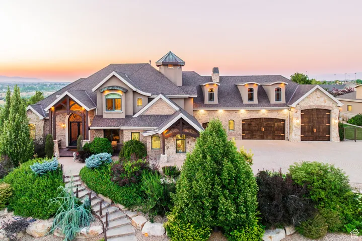 Stone and stucco exterior with multiple gables and dormer windows