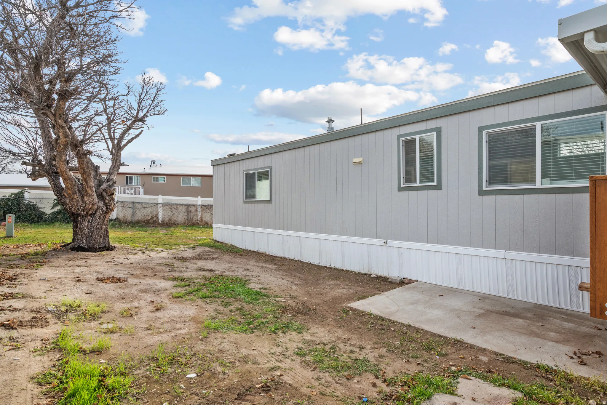 Light gray siding with white trim and multiple windows