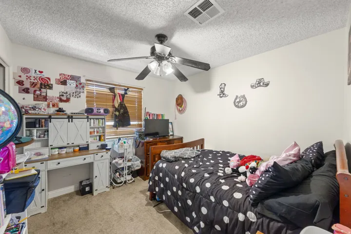 Light-colored walls complement the textured ceiling