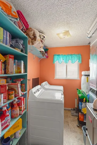 Dedicated utility area with a window providing natural light, overhead lighting, and built-in shelving