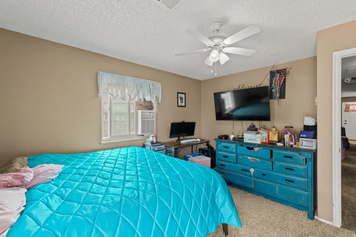 Bedroom featuring light brown walls and carpet flooring