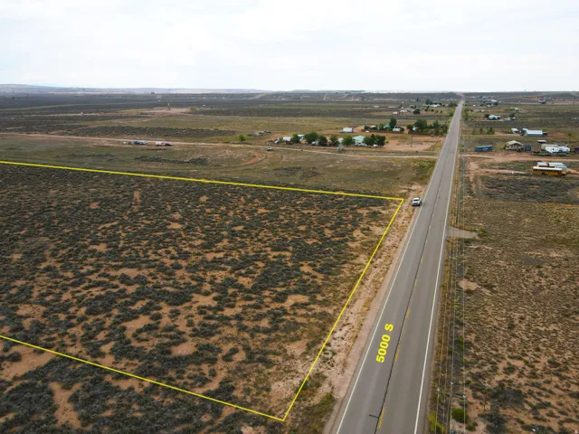 Expansive undeveloped lot featuring direct road frontage on 5000 S