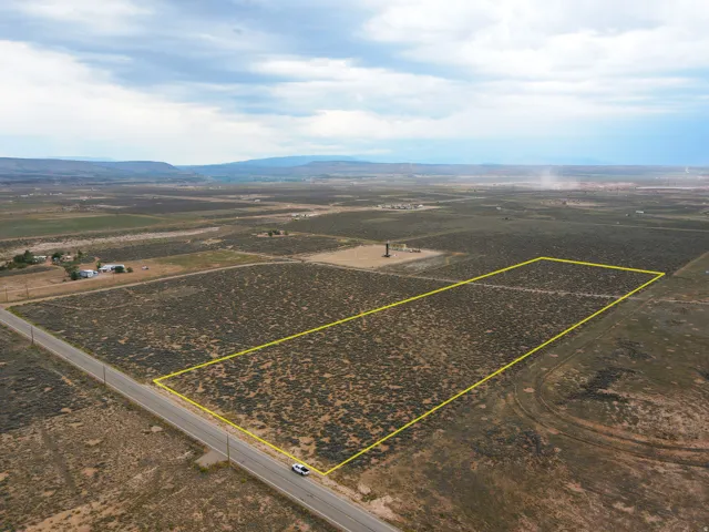 Expansive undeveloped land parcel with direct paved road frontage
