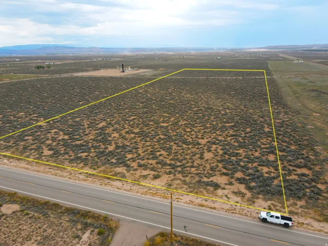 Expansive land parcel featuring direct road frontage and natural desert vegetation