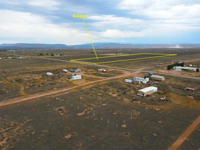 Expansive vacant land parcel featuring a flat topography and distant mountain backdrop