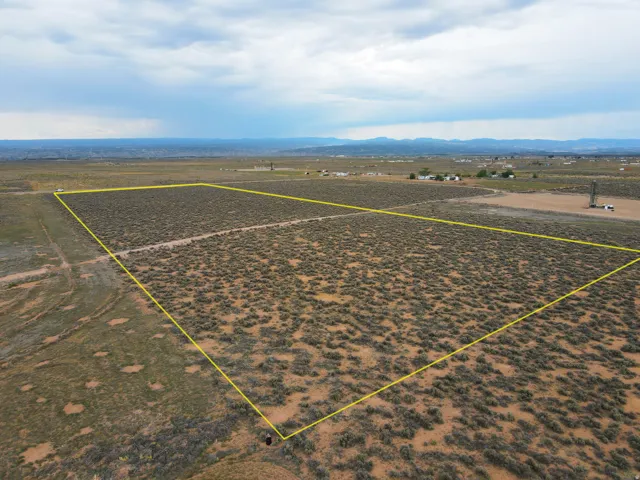 Expansive parcel featuring a defined boundary, natural desert flora, and distant mountainous terrain