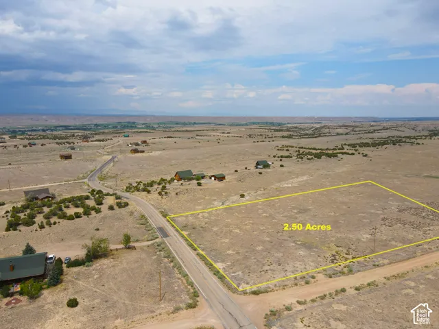 2.50-acre parcel featuring an unpaved road frontage and expansive desert landscaping