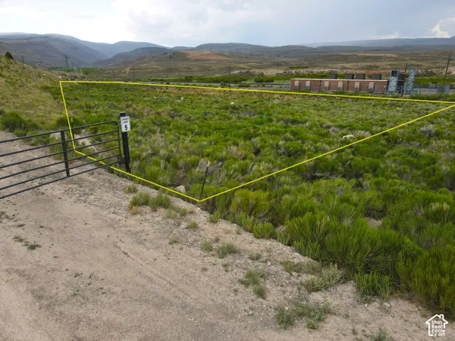 Expansive undeveloped land featuring natural shrubbery and a mountainous backdrop