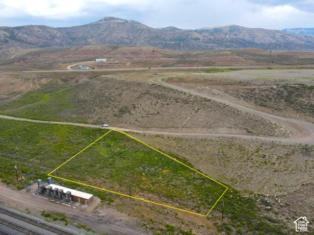 Expansive undeveloped parcel featuring a natural, vegetated landscape with distant mountain formations