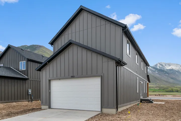 Contemporary residence featuring dark gray board-and-batten siding and black trim