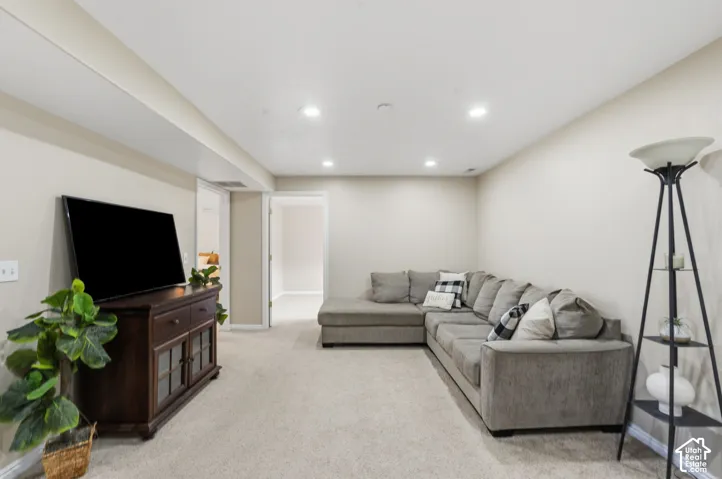 Spacious room featuring neutral carpeting, recessed ceiling lighting, and light-toned walls