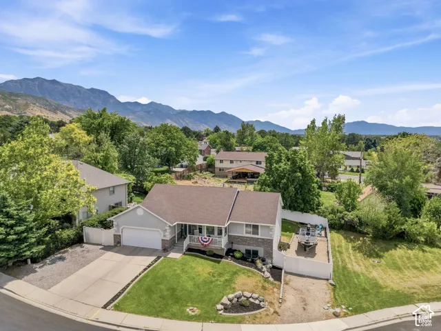 Traditional architecture with a two-car garage and a paved driveway