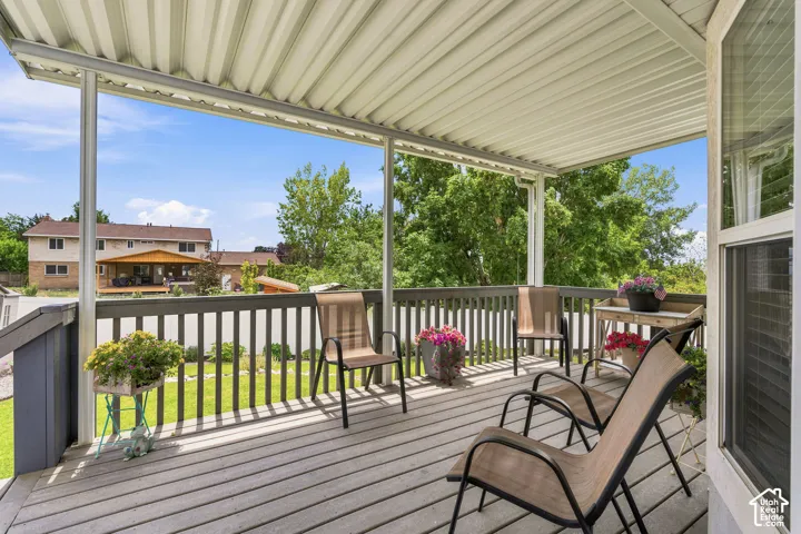 Covered outdoor deck featuring a corrugated metal roof and composite decking
