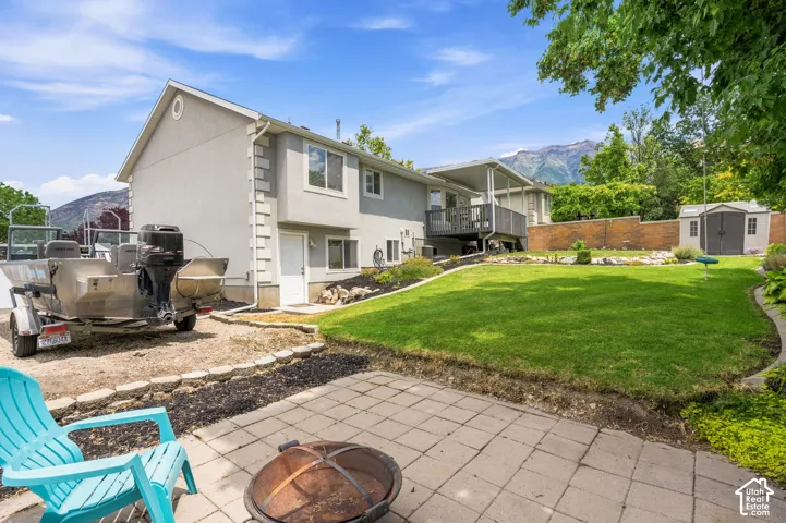 Expansive backyard with a large lawn area and a paved patio