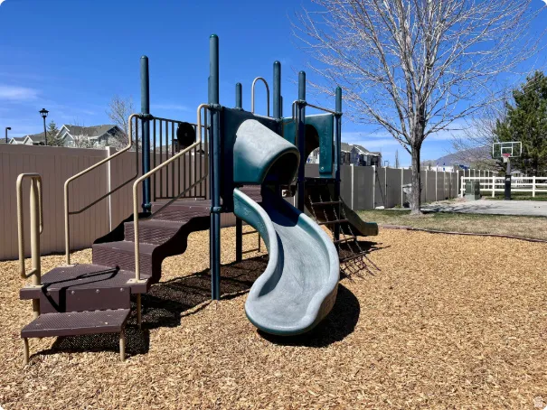 Recreational playground structure featuring multiple slides and climbing elements