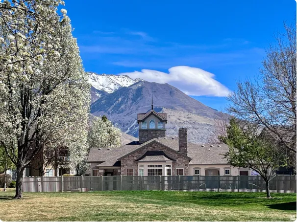 Stately stone and stucco residence featuring a distinctive cupola and pitched roofline