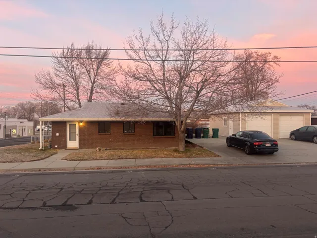 Brick exterior with a covered porch, an attached two-car garage, and a concrete driveway