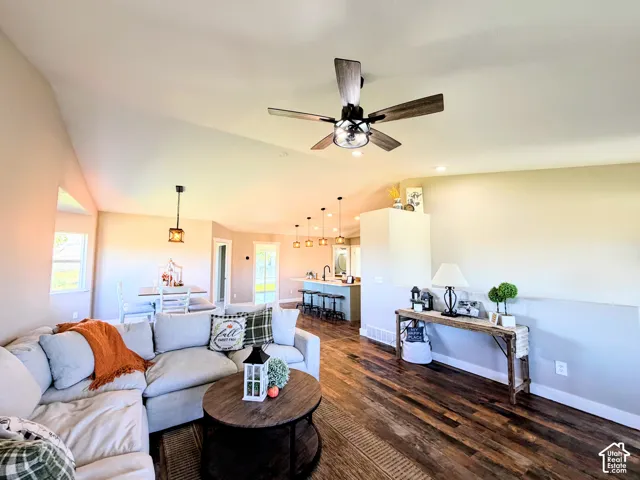 Vaulted ceiling, wood-finish flooring, recessed lighting, and a contemporary ceiling fan