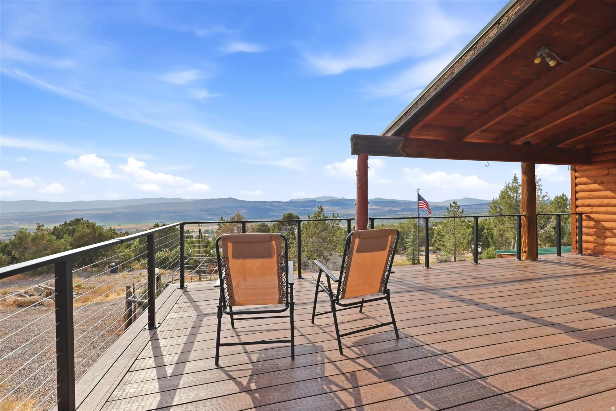 Deck features a new black cable railing system to allow full view of trees and valley