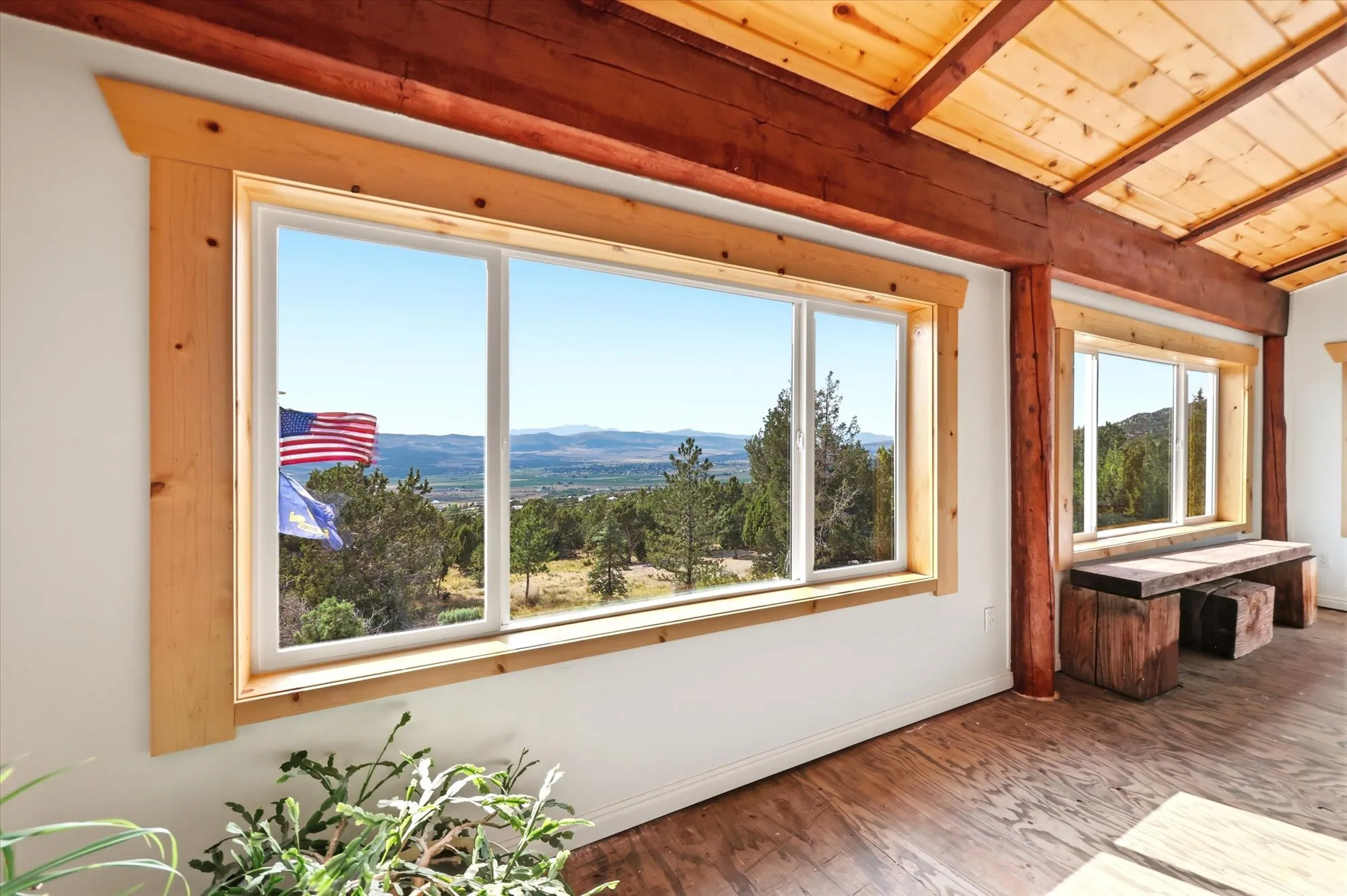 Four-season sunroom featuring large windows showing valley views